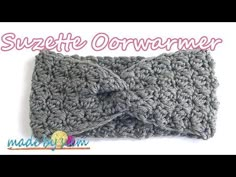 the crocheted headband is made with yarn and has a bow on it