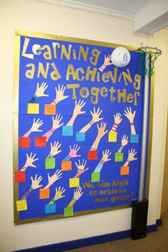 a bulletin board with handprints and writing on it that says learning is not achieving together