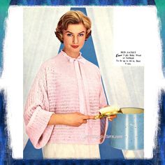 a woman in pink sweater holding a frying pan