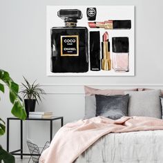 a bedroom with a chanel painting on the wall