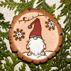 a wooden ornament with an image of a gnome on it