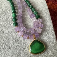 Elevate your style with our Amethyst and Jade Necklace – a unique green gemstone piece crafted for women. This handmade necklace makes a perfect birthday or anniversary gift for your wife,mom,sister or girlfriends. Explore the beauty of beaded jewelry and treat her to a truly special accessory. I use these pieces: - 10 mm jade and amethyst stones,- Small gold color hematite stones,- Cat eyes pendant. -18inches Spiritual Amethyst Round Bead Jewelry, Bohemian Gemstone Necklaces As Gift For Her, Spiritual Crystal Necklaces With Gemstone For Her, Spiritual Crystal Necklace With Gemstone For Her, Spiritual Gemstone Crystal Necklace For Her, Spiritual Crystal Gemstone Necklaces As Gift For Her, Elegant Jade Pendant Crystal Necklace, Elegant Round Jade Crystal Necklaces, Natural Stones Jewelry With Round Beads For Her