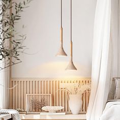 two hanging lights above a bed in a room with white walls and wood paneling