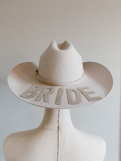 Personalized western bride hat perfect for wedding or bachelorette. Add your own personalized touch we recommend no more than 5 letters if more is needed please message us  Example: BRIDE WIFEY MRS MRS M Sizing: Small: 55cm Medium: 57cm Large: 59cm XL: 61cm please ensure you are purchasing your correct size, hats are not adjustable. Hat details: Our beautiful hats are lined with pink soft satin fabric to ensure your hair remains healthy and undamaged. The color is more of a creamy ivory beautifu Custom Adjustable Wedding Hats, Personalized White Wedding Hat, Personalized Adjustable Hats For Wedding, Adjustable White Hat For Anniversary, Customizable White Wedding Hats, Western Bride Hat, Cowboy Hat Bachelorette, Bride Cowboy Hat, Hat For Wedding