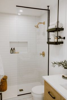 a bathroom with a toilet, sink and shower