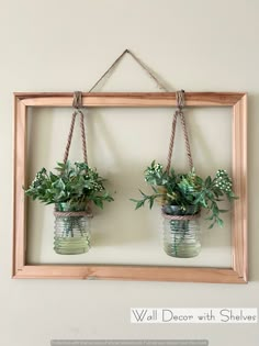 two mason jars with plants hanging from them