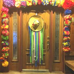 a door decorated with colorful streamers and a straw hat