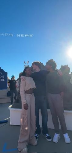 three people hugging each other on a boat