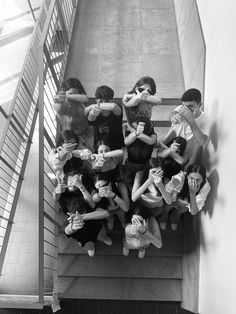 a group of people standing on top of a stair case