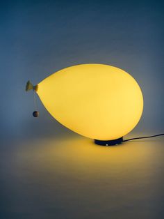 a yellow lamp sitting on top of a table