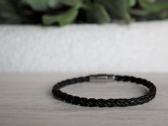 Handcrafted on Vancouver Island, this black leather bracelet is a versatile accessory. Wear this piece on its own, or with other bracelets or watches for a contemporary stacked look.  Featuring a stainless steel magnetic clasp, with an extra turn to lock, this bracelet is secure and durable. This excellent closure also makes it easy to take the bracelet on and off by yourself.  We have 4 different length options to ensure that you find the most perfect fit! To find your appropriate size, click t Modern Braided Leather Bracelets With Black Band, Modern Leather Braided Bracelet With Black Band, Modern Black Braided Bracelets With Stainless Steel Clasp, Modern Black Braided Bracelet With Leather Strap, Modern Leather Braided Bracelets, Modern Black Braided Bracelets As Gift, Modern Black Braided Bracelets For Gift, Classic Black Leather Bracelet For Gift, Modern Black Braided Bracelet Gift