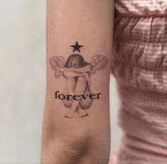 a woman's arm with a tattoo on it that says forever and an angel