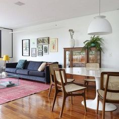 a living room filled with furniture and a large glass table in front of a window