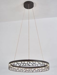 a circular light fixture hanging from the ceiling in a room with white walls and flooring