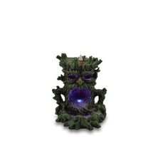 a green and purple vase with a blue light in it's center on a white background