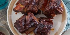 some ribs are on a plate with sauce