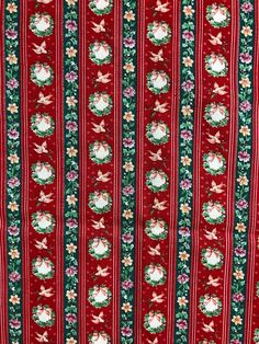 a red and green striped fabric with christmas decorations on the side, featuring santa claus