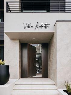 an entrance to a building with steps leading up to it and a planter in the foreground