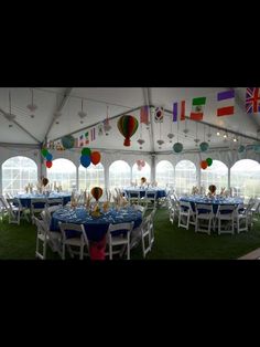 the inside of a tent with tables and chairs set up for an event or party