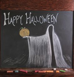 a chalkboard drawing of a ghost with a pumpkin on it