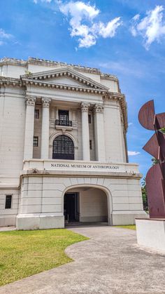 the national museum of astrology is located in front of a large white building with columns and arches