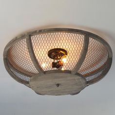 the light fixture is made out of wood and has chicken wire on it's sides