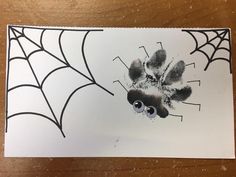 a drawing of a spider web with eyes on it's back and hands in the center