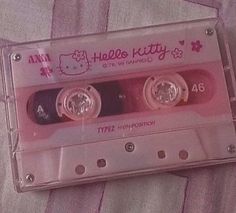 an old hello kitty cassette tape with two rings on the front and one in the back