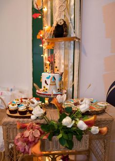 a table with cupcakes and flowers on it