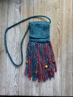 a handmade purse sitting on top of a wooden floor