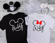 two tshirts with mickey and minnie mouse heads on them, one is black and the other is white