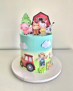 a colorful cake with farm animals on it