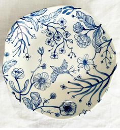 a blue and white plate with flowers on it