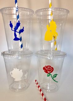 three plastic cups with different colored straws in them and one has an image of beauty and the beast on it