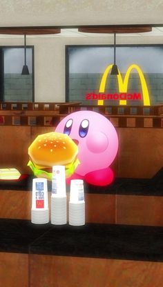 an animated hamburger and some ketchup on a counter in a fast food restaurant