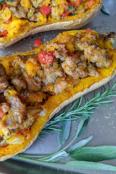 two stuffed delicacies sitting on top of a plate with herbs and seasoning