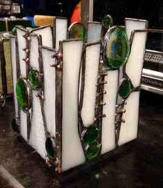 an old stained glass and metal box on a counter