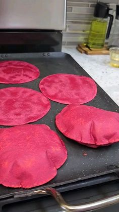 four red circles are on top of an open oven and it's ready to be cooked