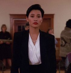 a woman in a black suit and white shirt