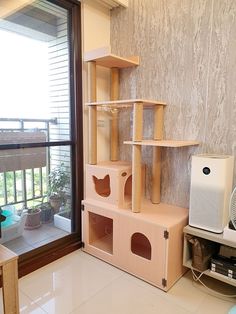 the cat house is made out of cardboard and has several shelves on each side, along with an air conditioner