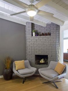 a living room with two chairs and a fire place