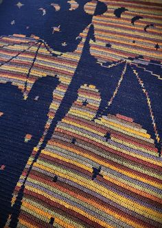 a close up of a rug with an umbrella on it