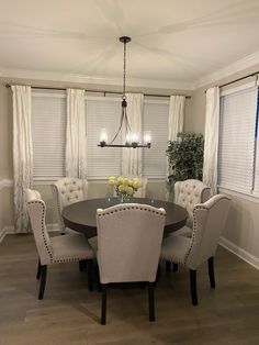 a dinning room table with chairs around it