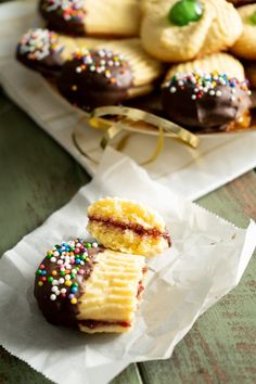 there are many cookies and pastries on the table with one cookie cut in half