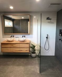 a bathroom with two sinks and a shower