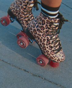 a person in leopard print boots riding on a skateboard