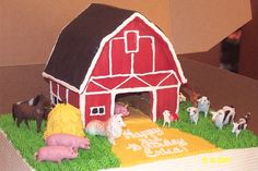 a cake decorated with farm animals and a barn