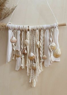 a wall hanging with seashells on it