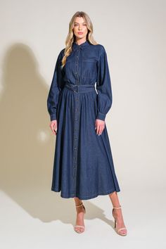 A light weight denim midi dress featuring shirt collar, button down, front pockets, long sleeve, self belt and full skirt Details: Self : 100% Cotton Size & Fit - Model is 5`8" And Wearing Size Small- Measurements Taken From Size Small- Approx. Length: 50" Denim Blue Long Sleeve Dress With Buttoned Pockets, Belted Midi Denim Dress In Medium Wash, Casual Midi Denim Dress With Pockets, Casual Midi Length Denim Dress With Pockets, Belted Medium Wash Dress For Work, Medium Wash Denim Midi Dress With Button Closure, Fall Casual Midi Denim Dress, Chic Denim Shirt Dress For Work, Belted Denim Midi Dress