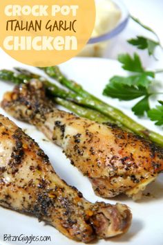 grilled chicken and asparagus on a white plate with the words crock pot italian garlic chicken